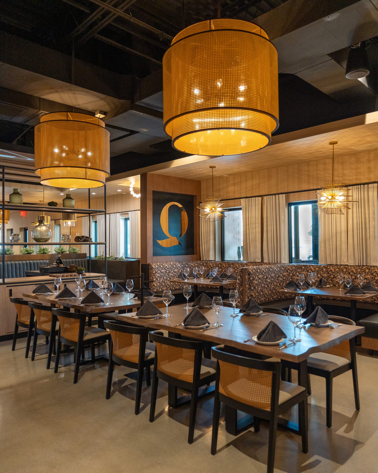 The dining room, with woven pendant lamps and the Quiriego Q on the wall