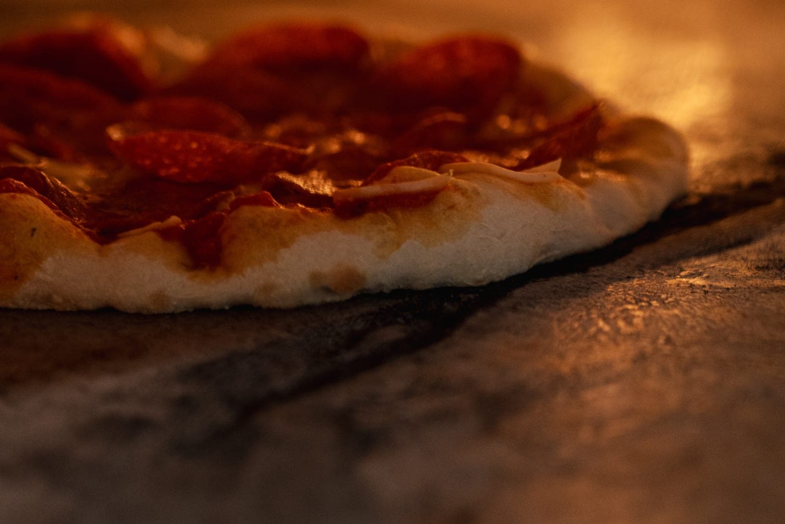 A pepperoni pizza baking in the oven