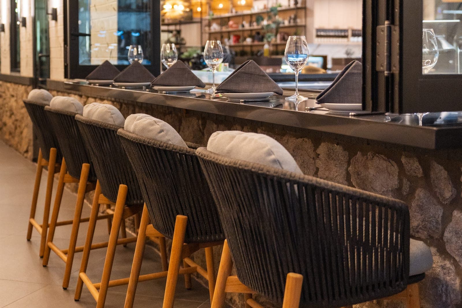 Woven stools along the bar counter